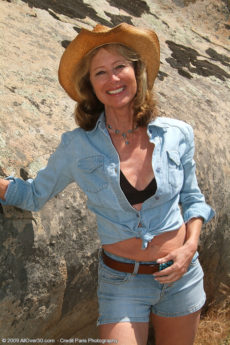 61 year old Janet L peels of her blue jeans and spreads on the rocks
