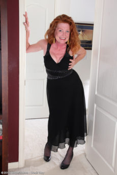 Redheaded 48 year old mature woman Tami Estelle takes off her dress and spreads her legs