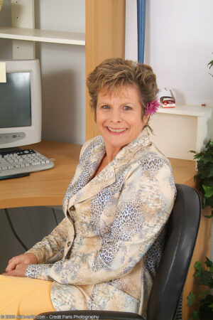 50 plus secretary Judy takes off her clothes at her desk