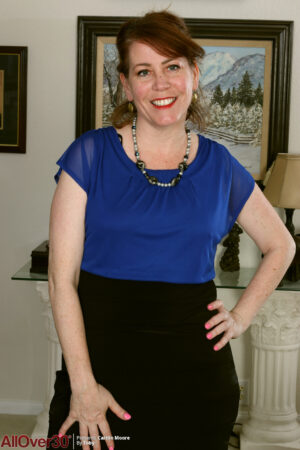 Curvy redhead Caitlin Moore has a great smile and lovely big tits